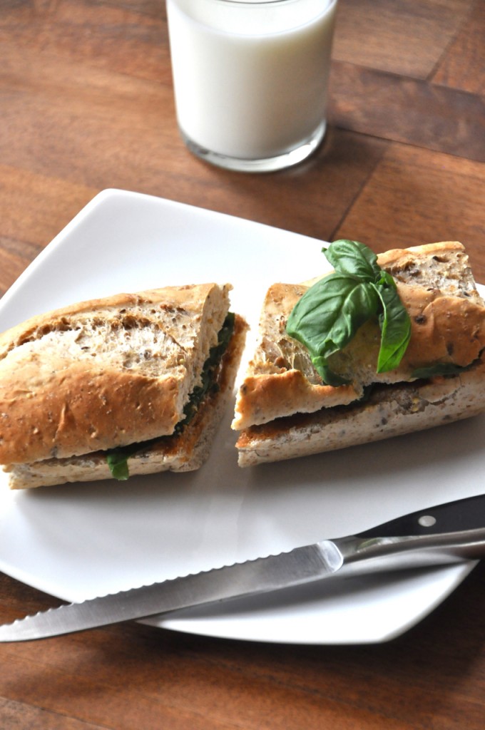 Glass of almond milk and a Basil and Peanut Butter Sandwich for a simple vegan lunch