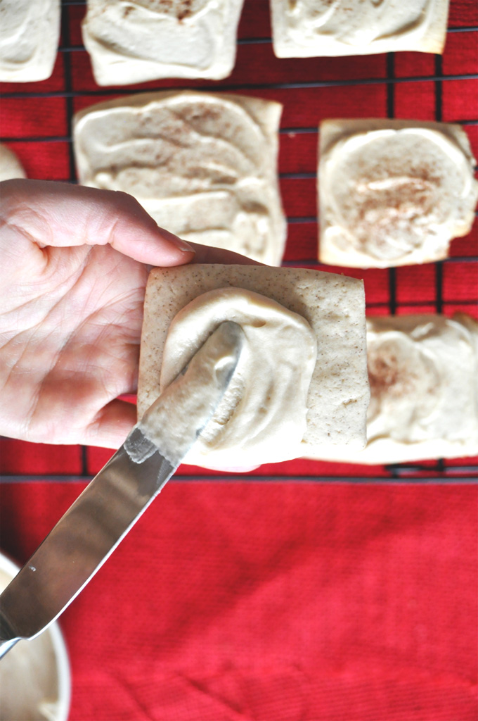 Spreading frosting onto a French Toast Sugar Cookie