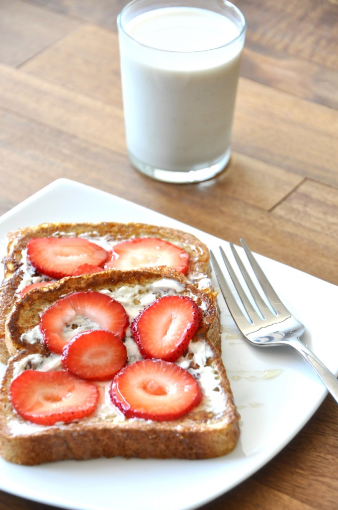 Plate with slices of Strawberry Danish French Toast alongside a glass of milk