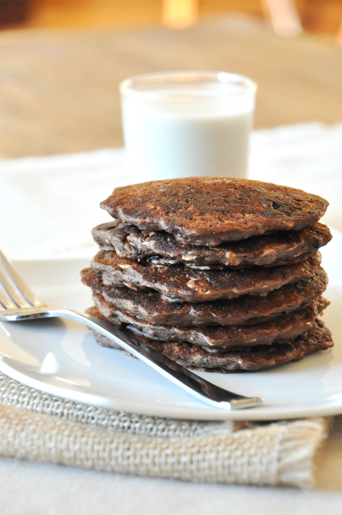 Stack of No-Bake Cookie Pancakes alongside a glass of soy milk