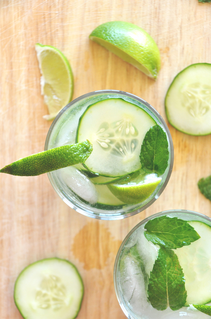 Cutting board with two glasses of our Cucumber Cooler Cocktails recipe