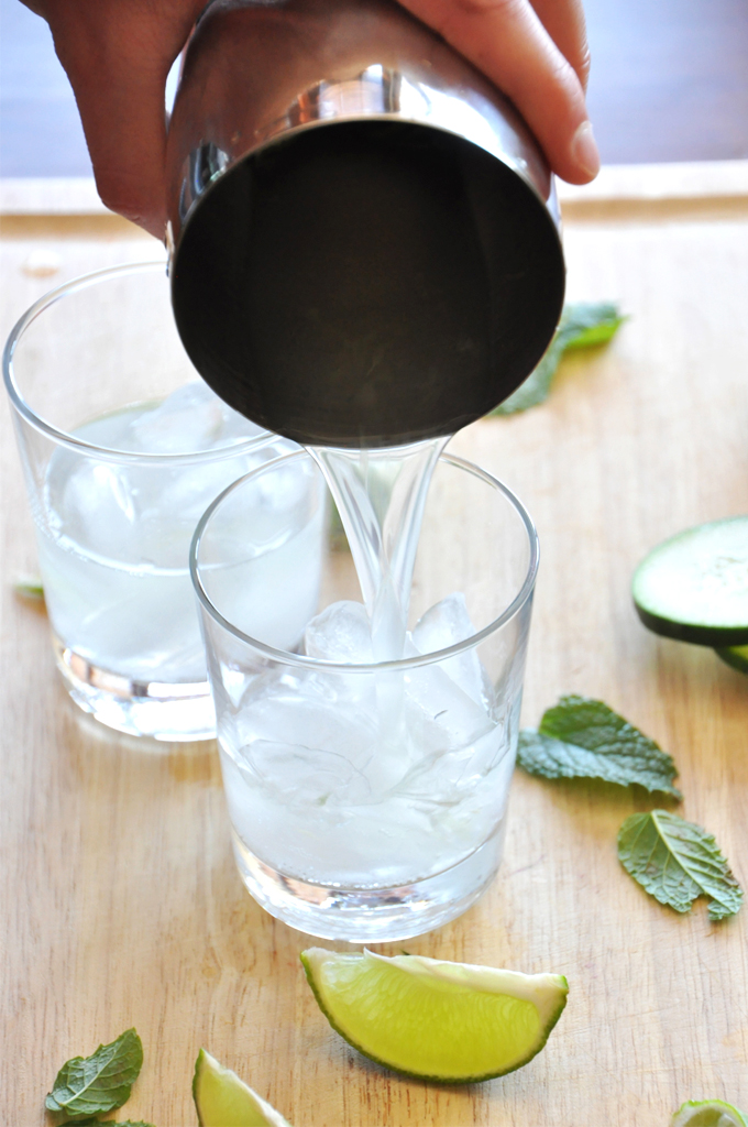 Pouring two glasses of our Cucumber Cooler Cocktails recipe