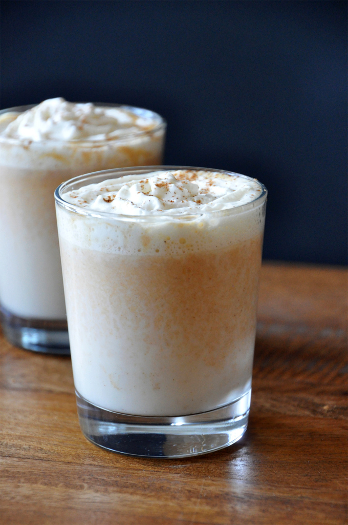 Glasses of Boozy Pumpkin White Hot Chocolate topped with whipped cream