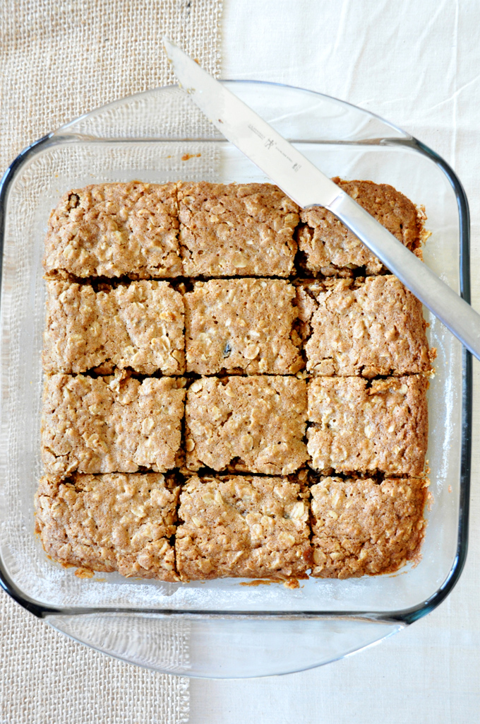 Baking pan with a sliced batch of Chai-Spiced Oatmeal Raisin Bars
