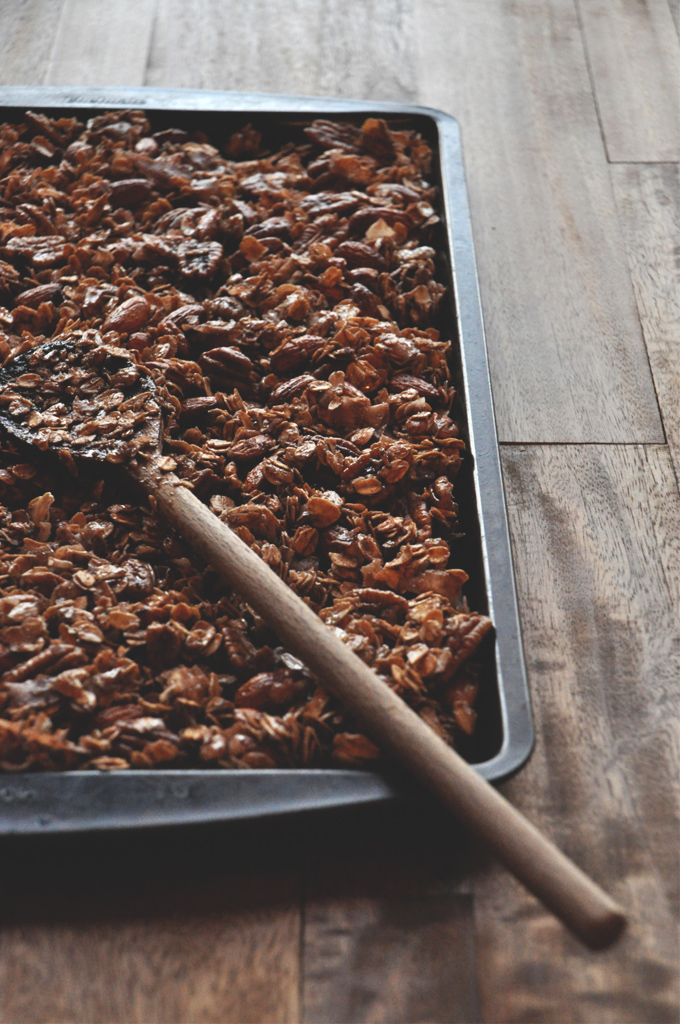 Coconut Honey Granola || Minimalist Baker Stirring a baking pan filled with a batch of our Nut and Honey Coconut Granola recipe
