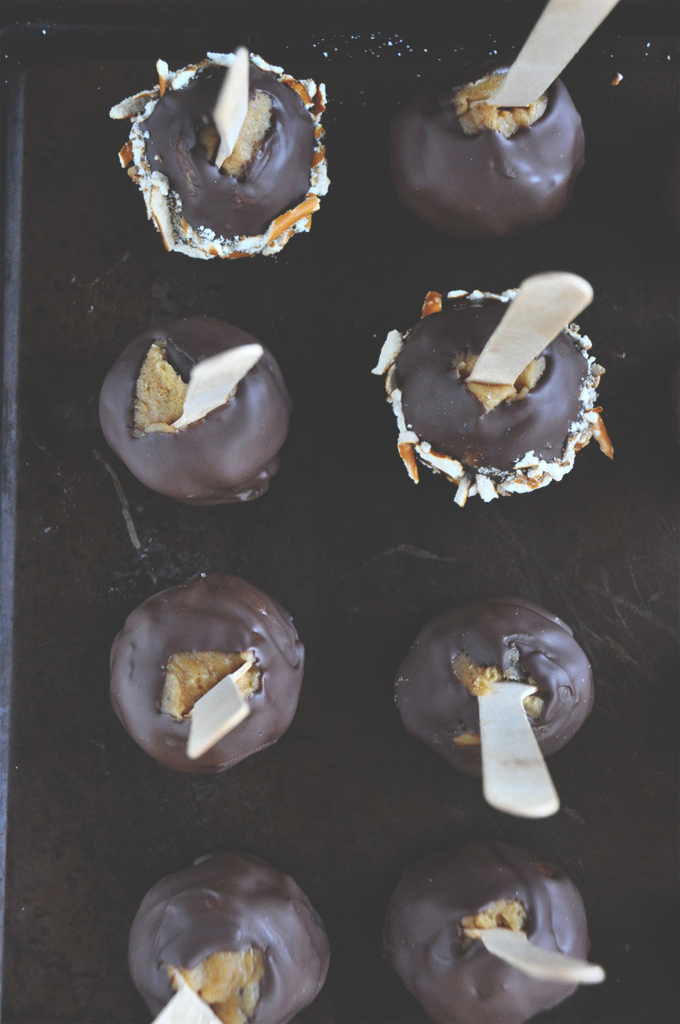 Batch of Pumpkin Cookie Dough Pops covered in chocolate and nuts