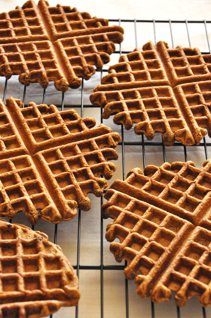 Batch of homemade Vegan Gingerbread Waffles on a cooling rack