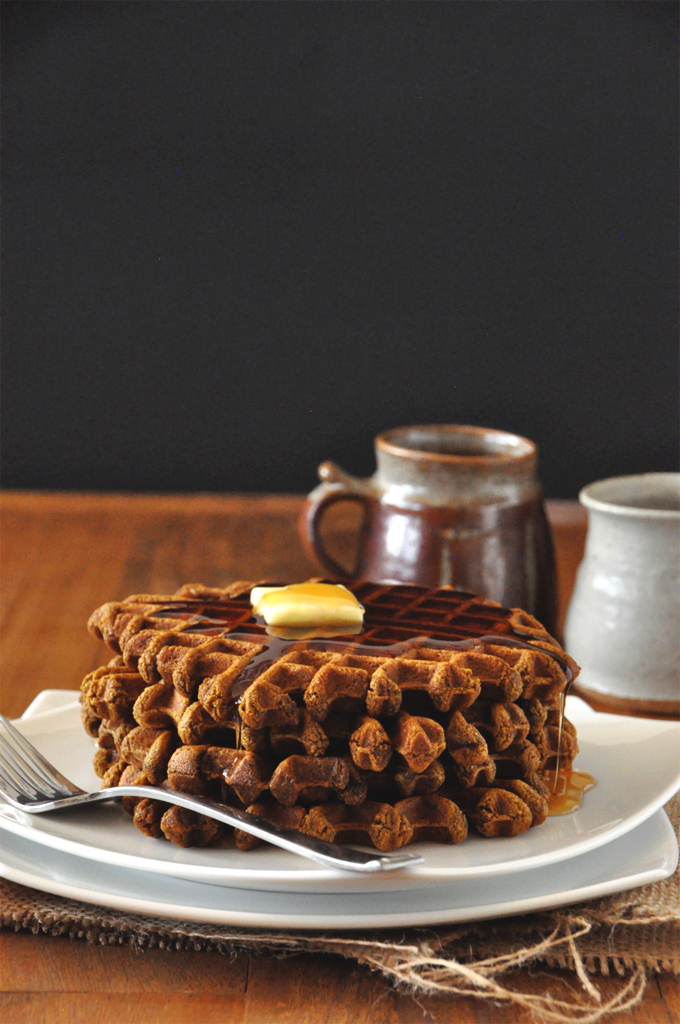 Stack of a batch of our simple Vegan Gingerbread Waffles topped with syrup and butter