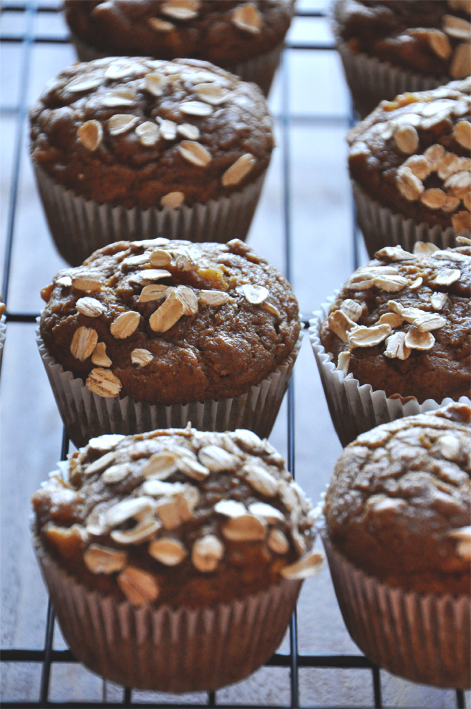 Vegan Pumpkin Apple Muffins - Minimalist Baker Cooling rack with a batch of Vegan Pumpkin Apple Muffins topped with oats