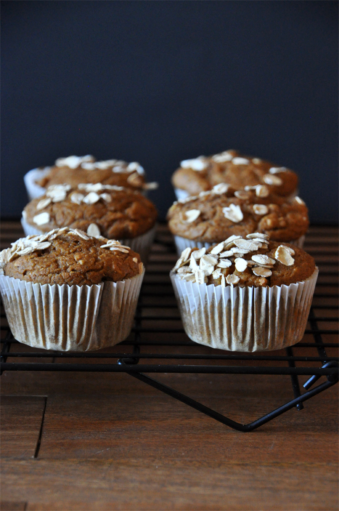 Vegan Pumpkin Apple Muffins - by Minimalist Baker Cooling rack with a batch of our Vegan Pumpkin Apple Muffins topped with oats