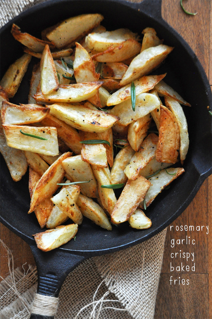 Cast-iron skillet filled with a batch of our homemade Crispy Baked Rosemary Garlic Fries