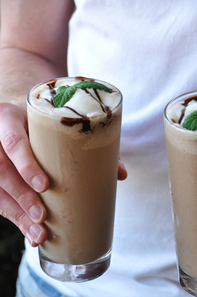 Holding two glasses of our Peppermint Mocha Frappe for a refreshing summer beverage
