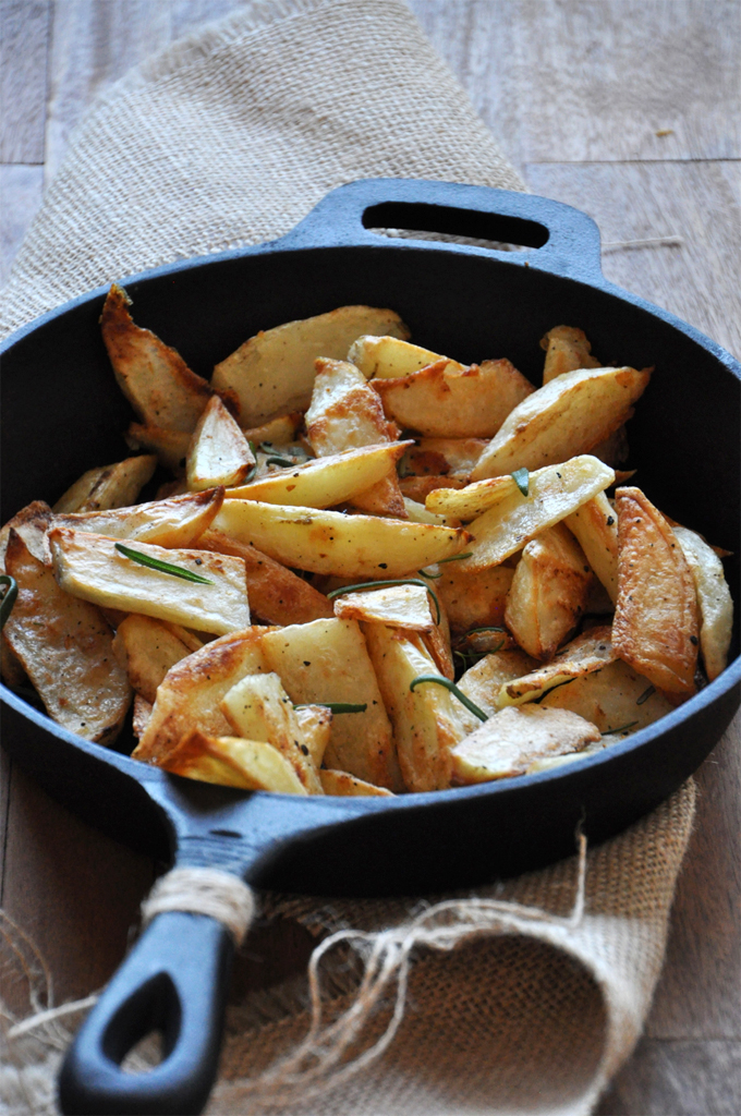 Batch of our Crispy Baked Rosemary Garlic Fries recipe in a cast-iron skillet