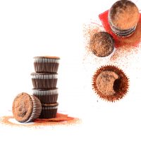Stacks of Fudgy Vegan Beet Cupcakes topped with cocoa powder