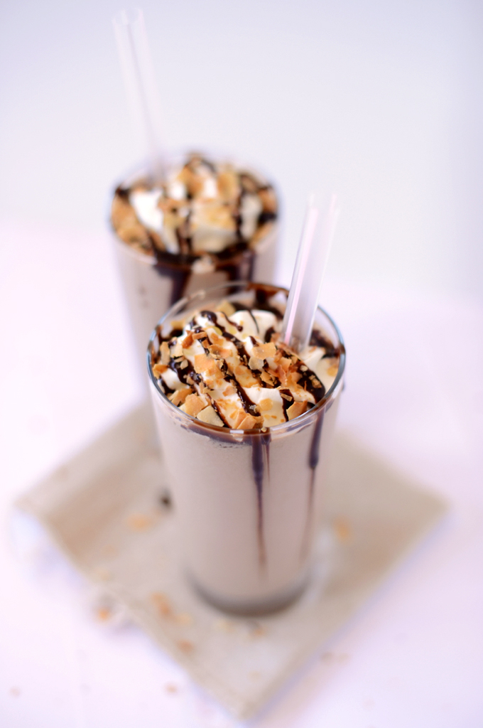Two tall glasses of our Toasted Coconut Frappuccino recipe topped with extra coconut