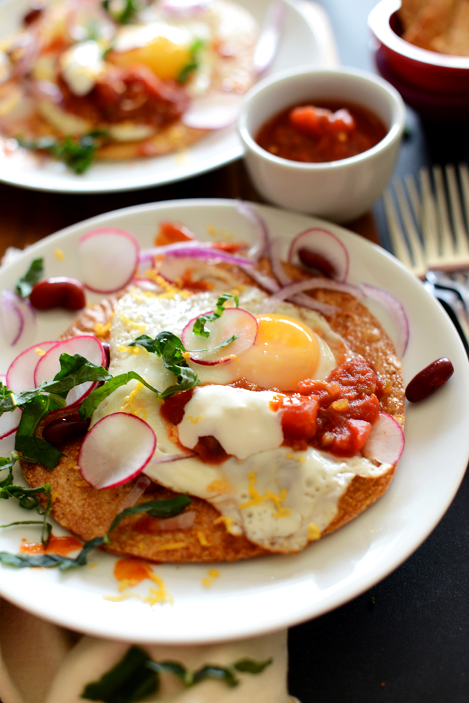 Close up shot of a plate of our Gluten-Free Breakfast Tostada topped with radish and kale