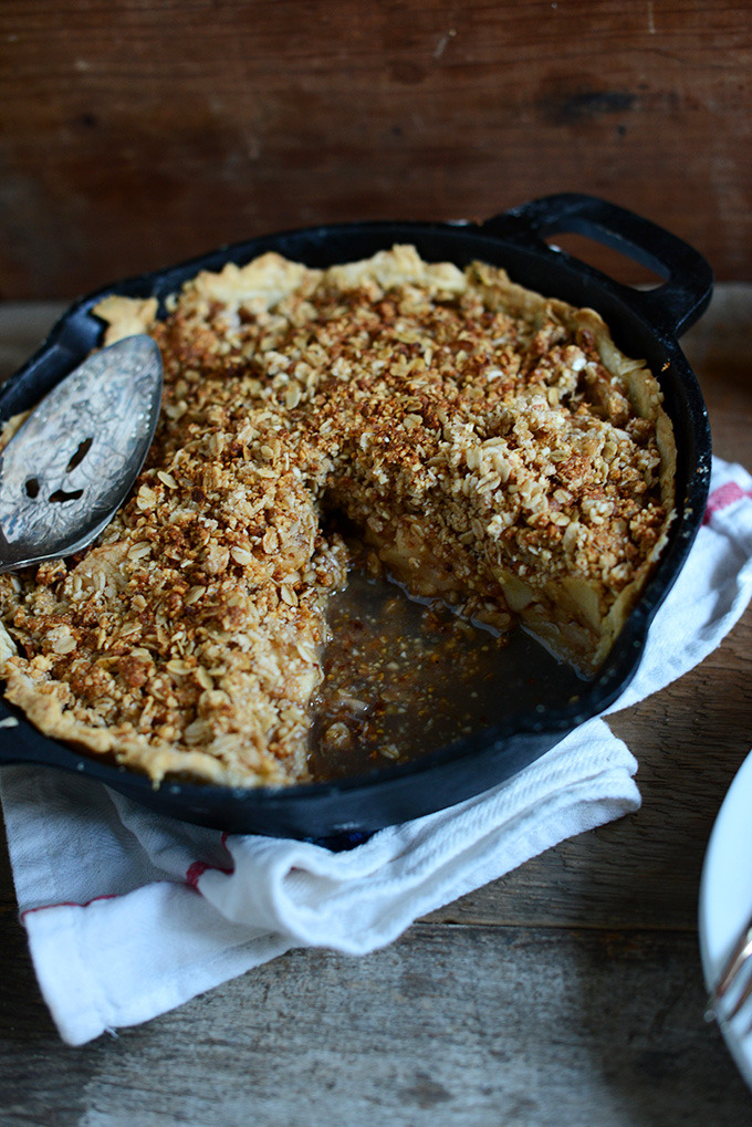 Cast-iron skillet filled with vegan Deep Dish Apple Crumble Pie