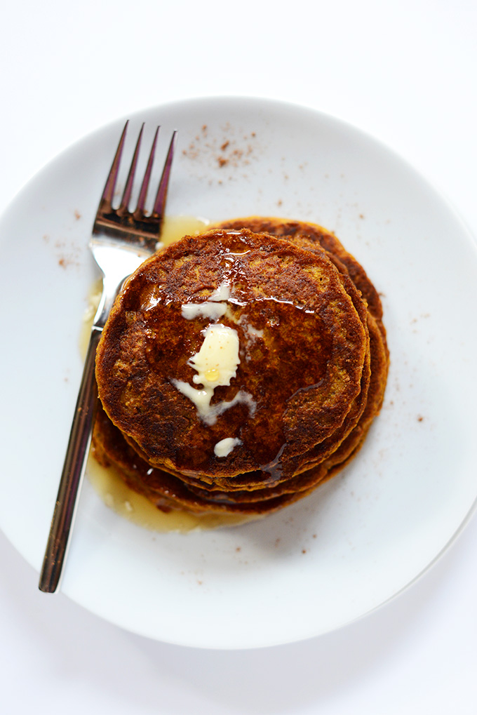 Fork resting on a plate alongside a stack of Vegan Pumpkin Spice Pancakes