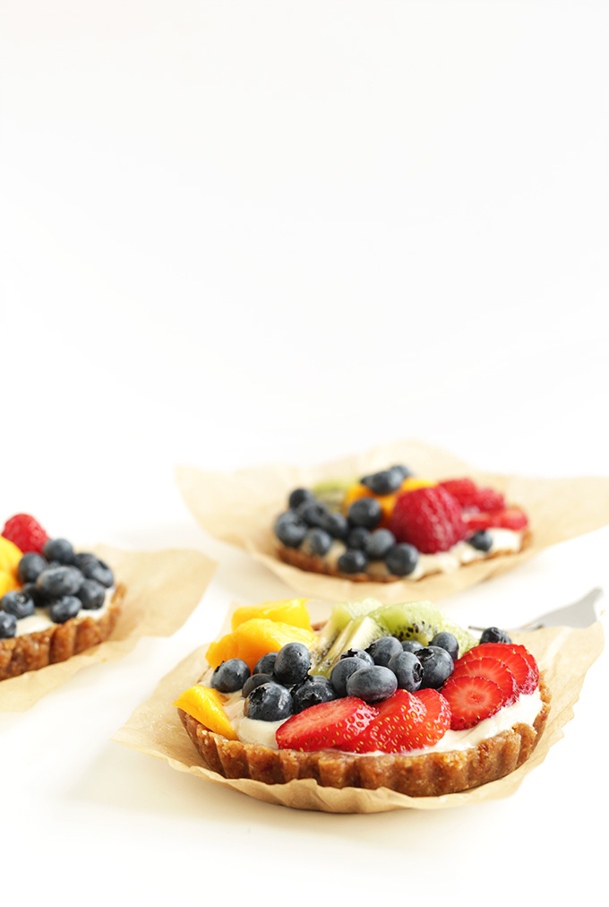 Three of our gluten-free vegan Lemon Cookie Fruit Tarts 