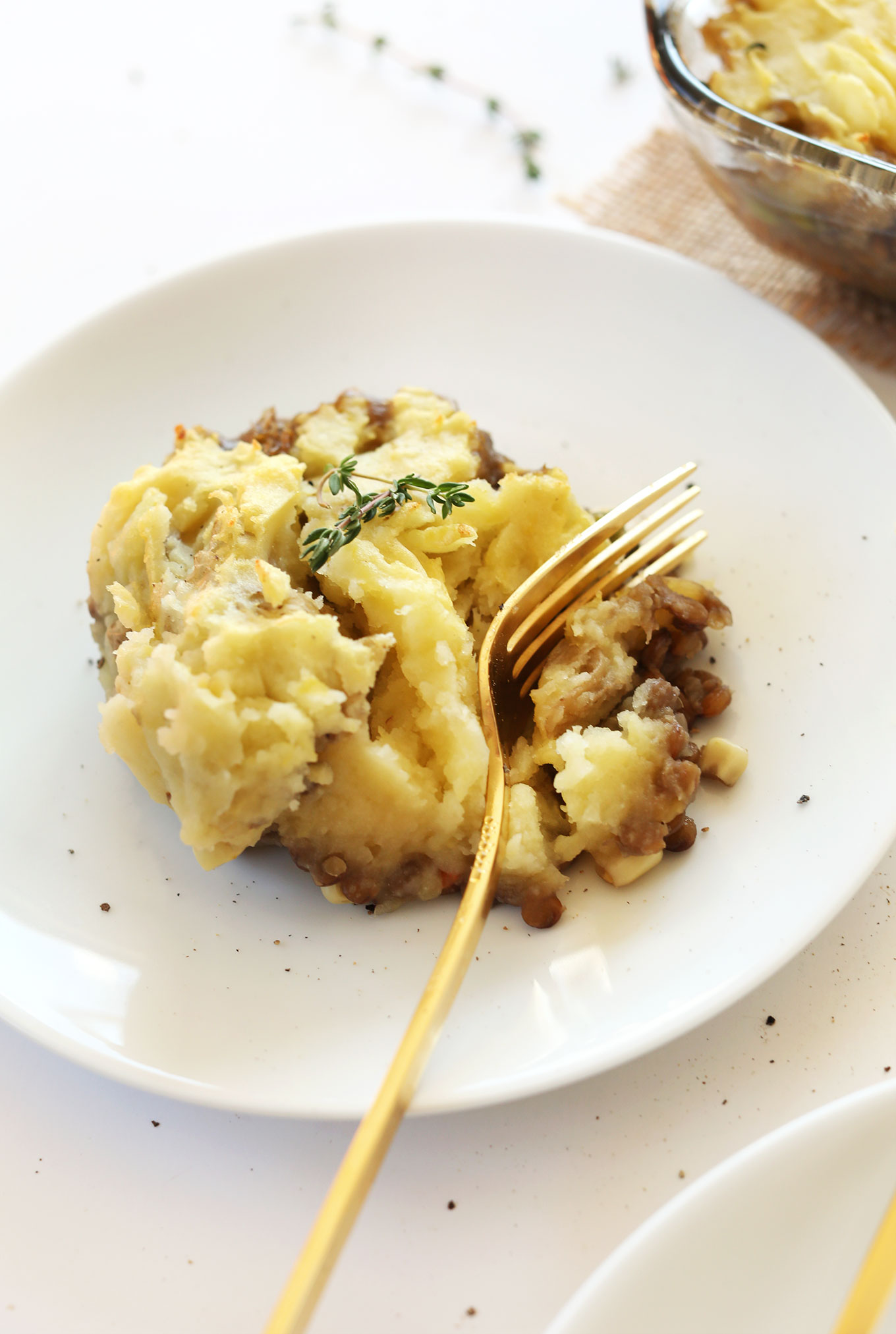 Using a fork to slice into a serving of Vegan Lentil Shepherds Pie