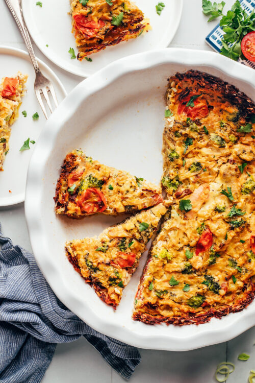 Partially sliced vegan tofu quiche in a pie pan