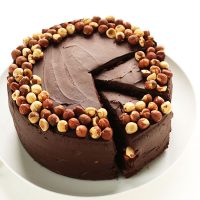 Partially sliced plate of Vegan GF Chocolate Hazelnut Cake