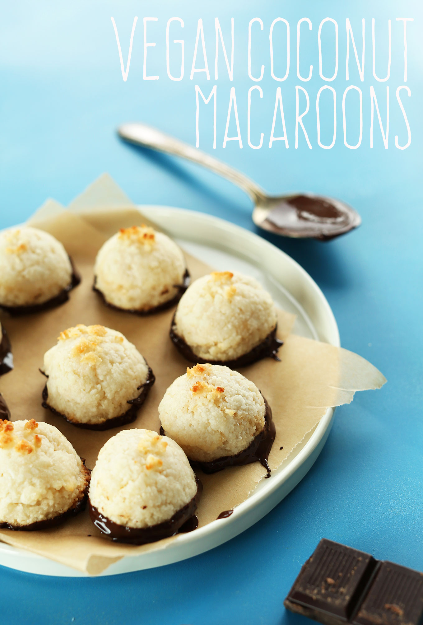 Plate of gluten-free vegan Coconut Macaroons freshly dipped in dark chocolate