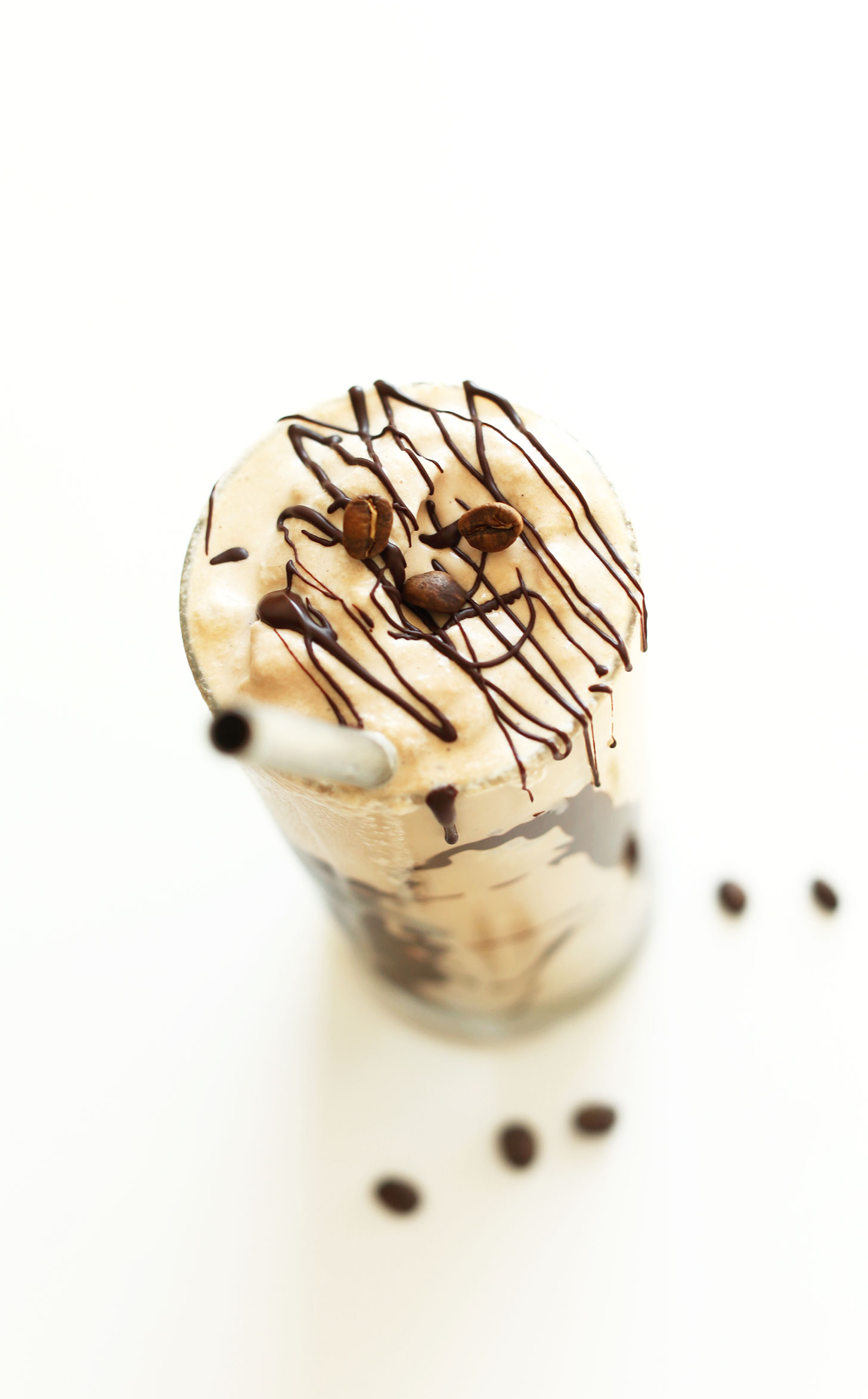 Glass of our vegan mocha shake topped with a chocolate magic shell drizzle
