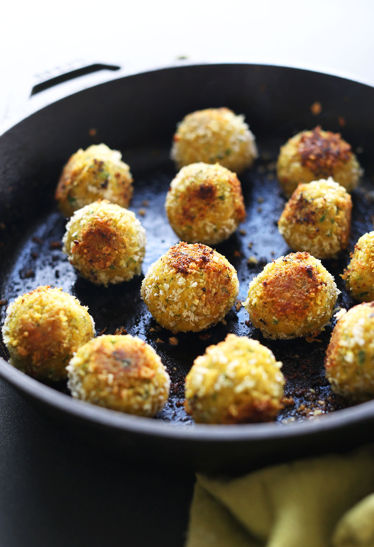 Cast-iron skillet filled with our healthy vegan Turmeric Chickpea Fritters 