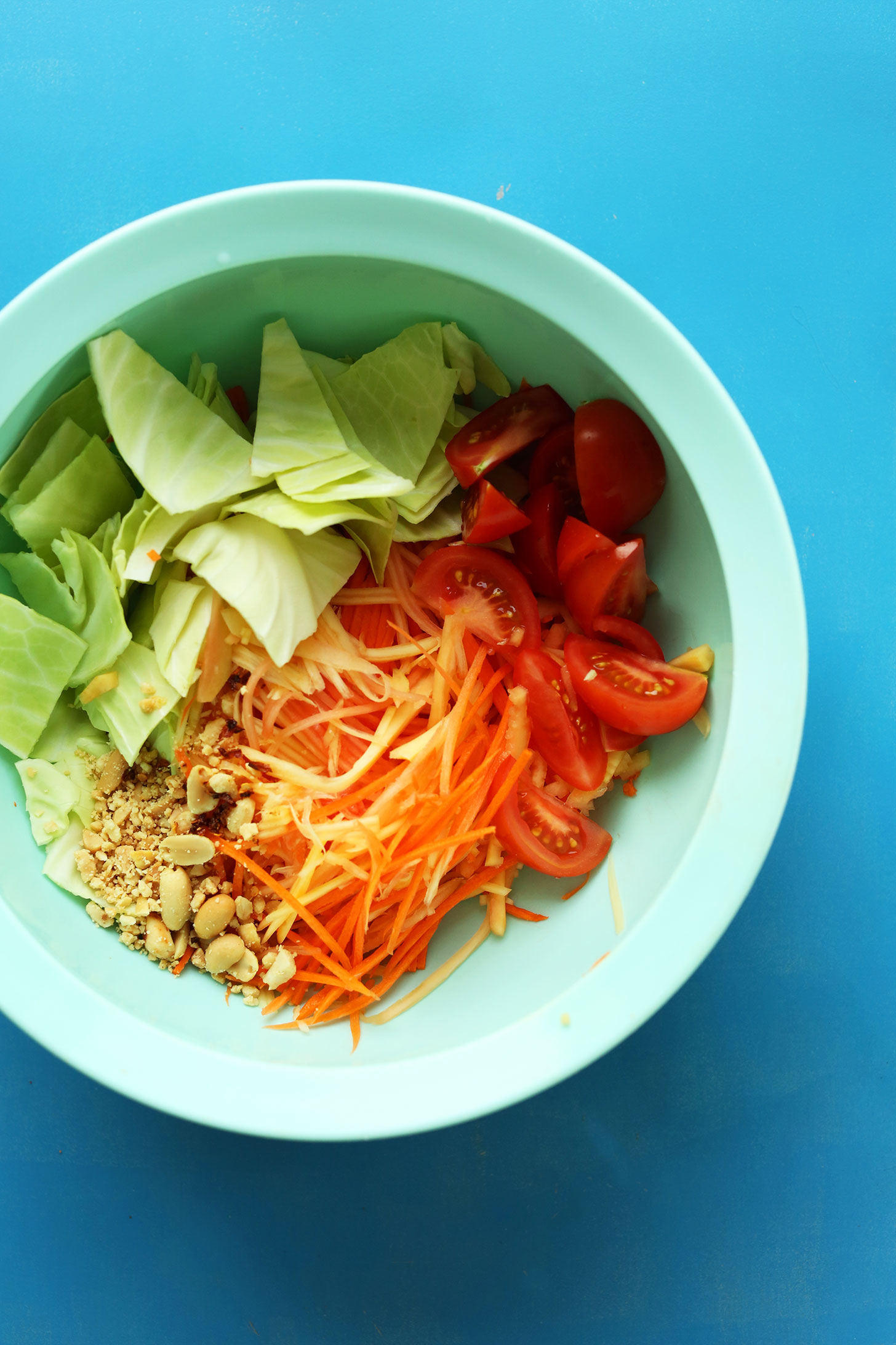 Mixing bowl with ingredients for our gluten-free vegan Thai Papaya Salad 