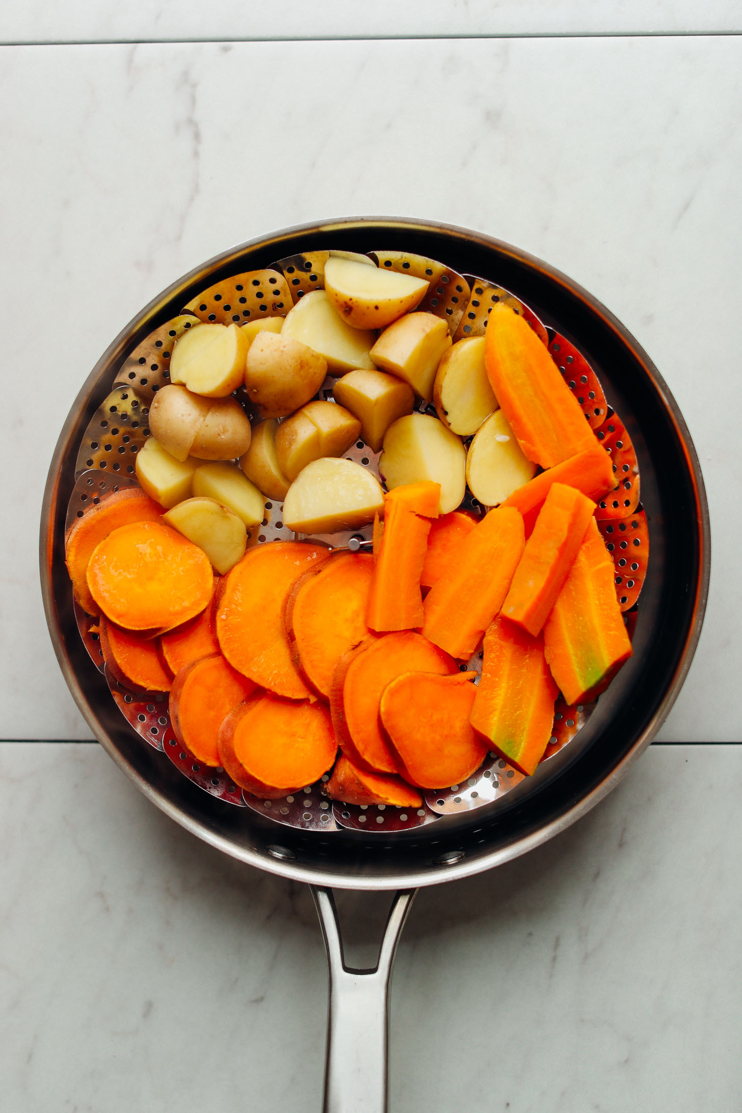 Steaming potatoes, sweet potatoes, and carrots