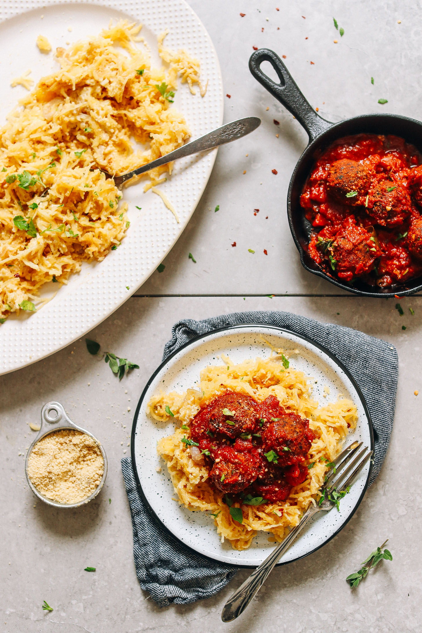 Plate of vegan Cheesy Spaghetti Squash Pasta topped with homemade vegan meatball marinara