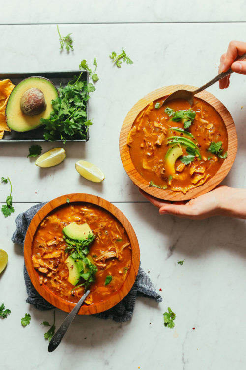 Wood serving bowls filled delicious Vegan Tortilla Soup made with jackfruit