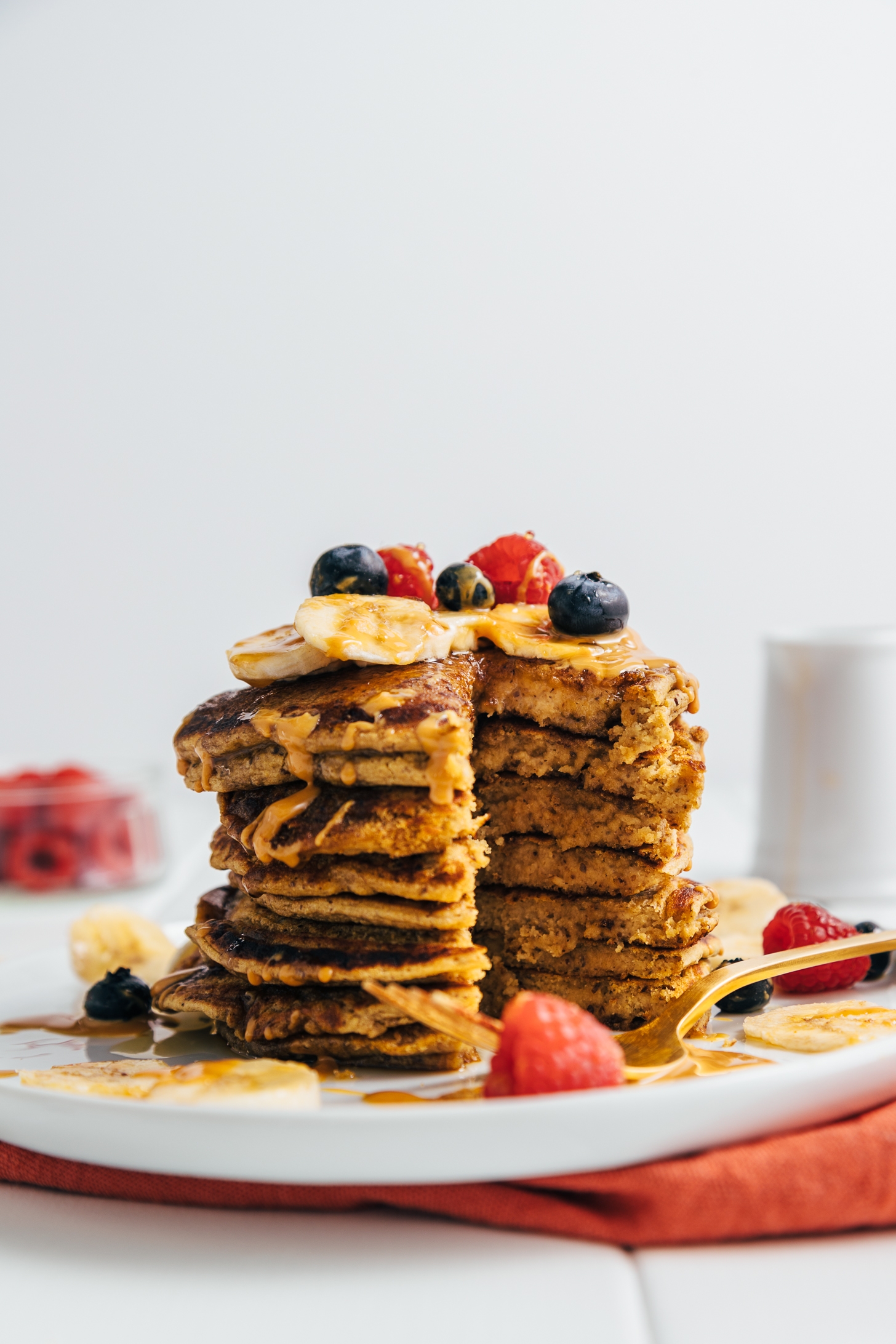Stack of Peanut Butter Protein Pancakes with a tall slice removed