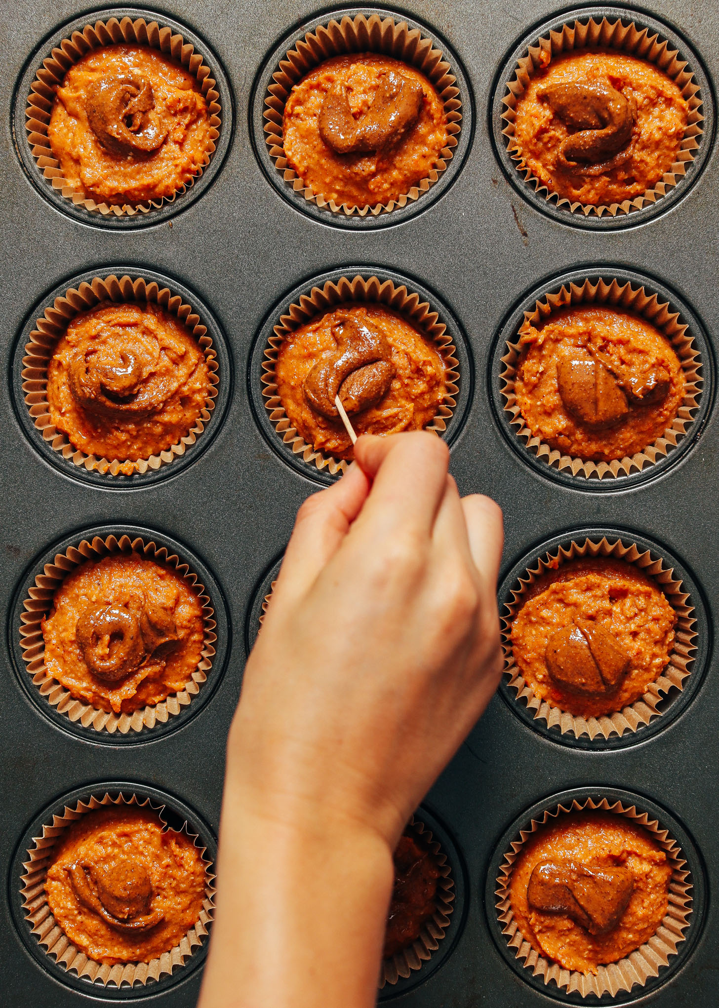 Muffin tin filled with batter for making our Almond Butter Sweet Potato Muffins 