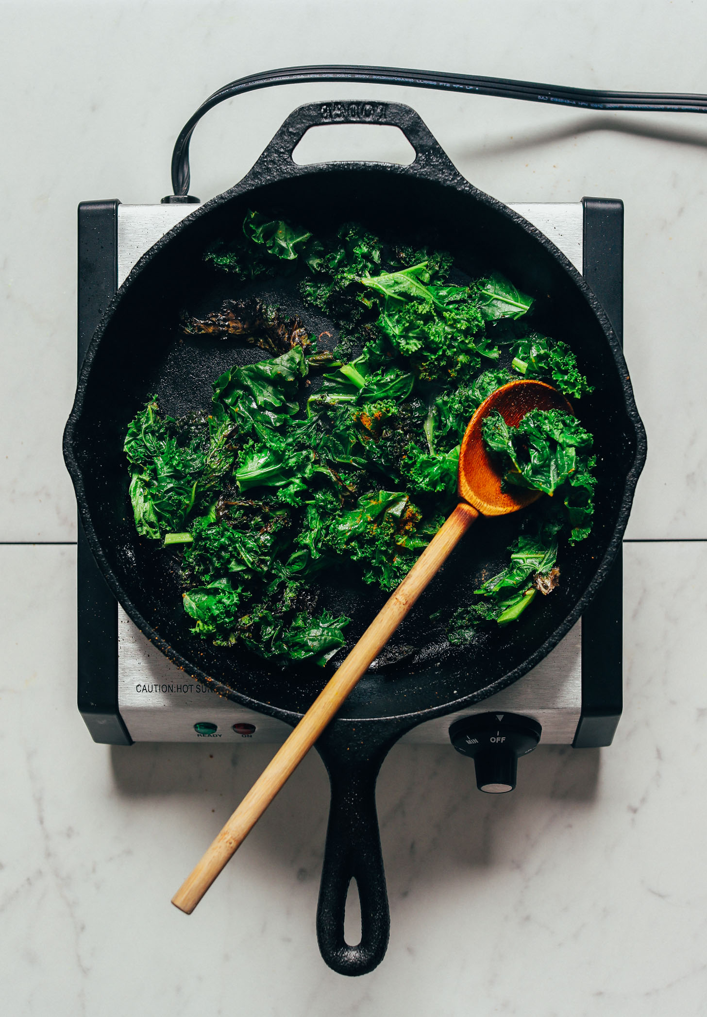 Sautéing kale in a cast iron skillet