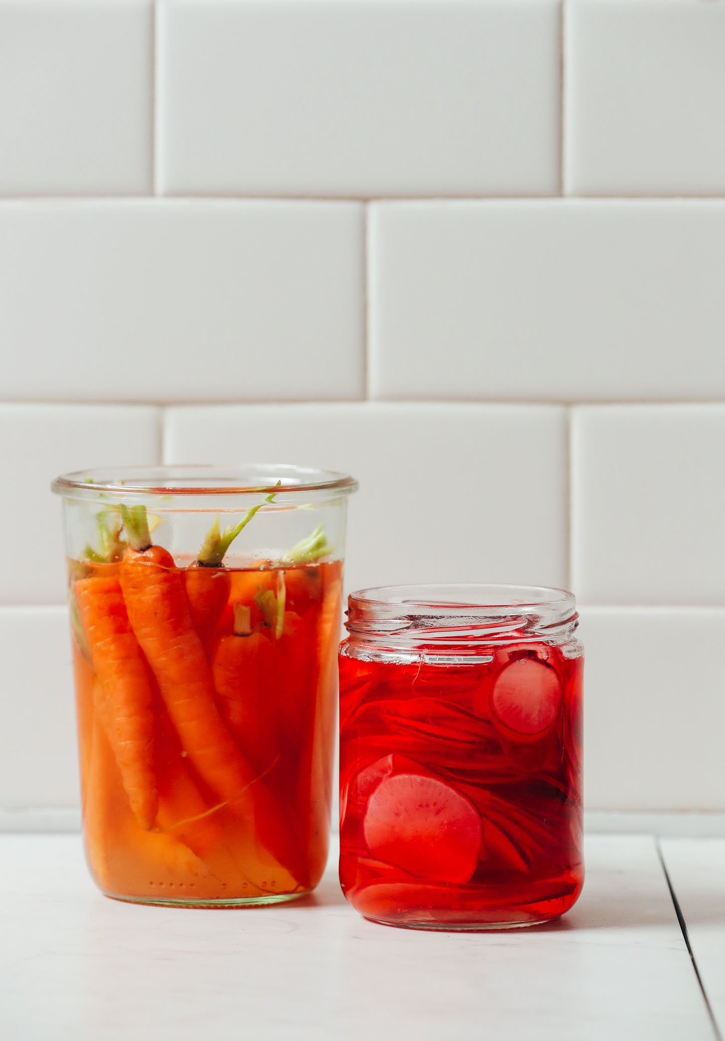 Large jars filled with our Quick Pickled Carrots and Radish