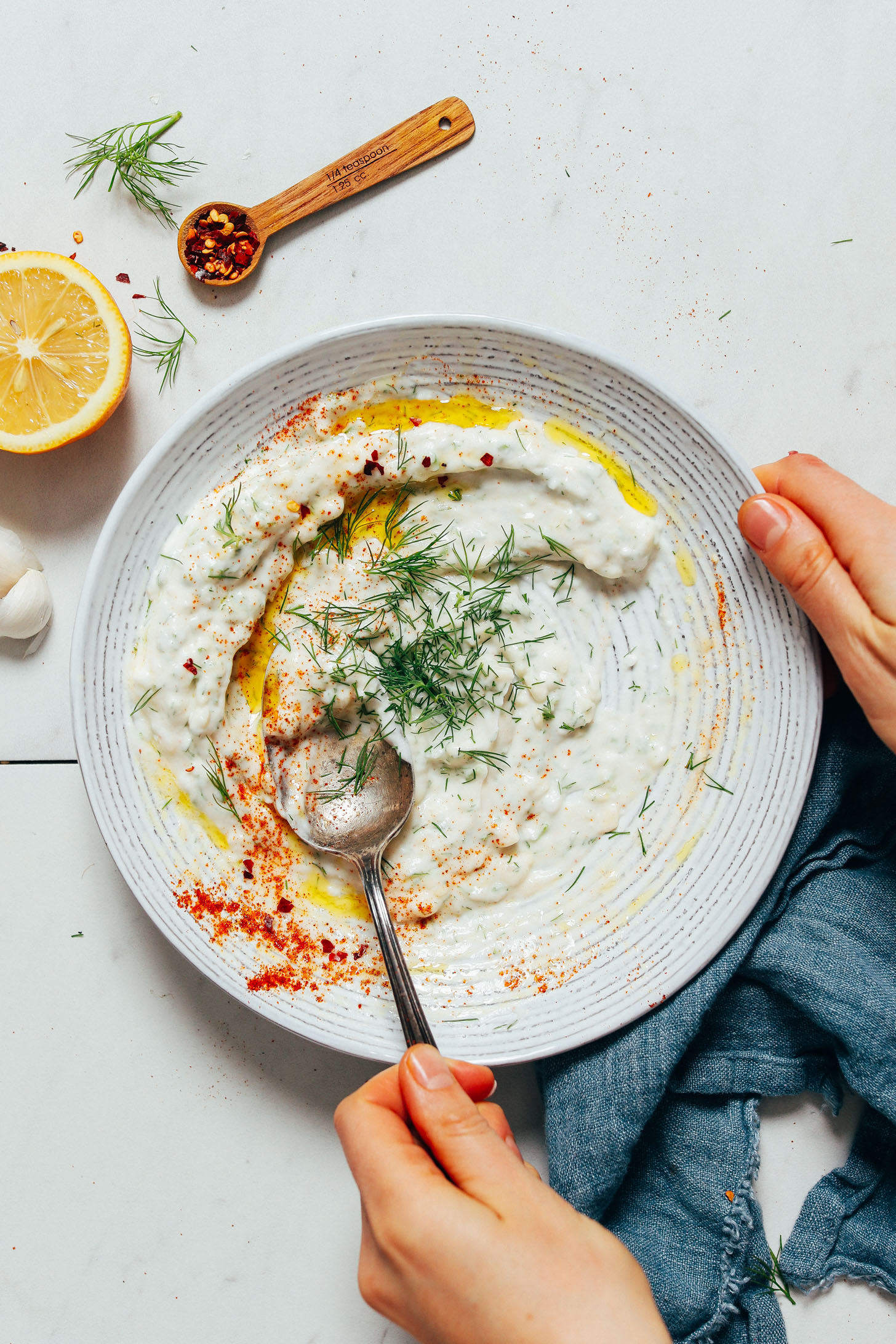 Fresh dill atop a bowl of our Zesty Dill Yogurt Sauce