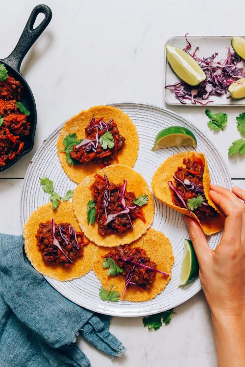 Plate of corn tortillas filled with Vegan Taco Meat