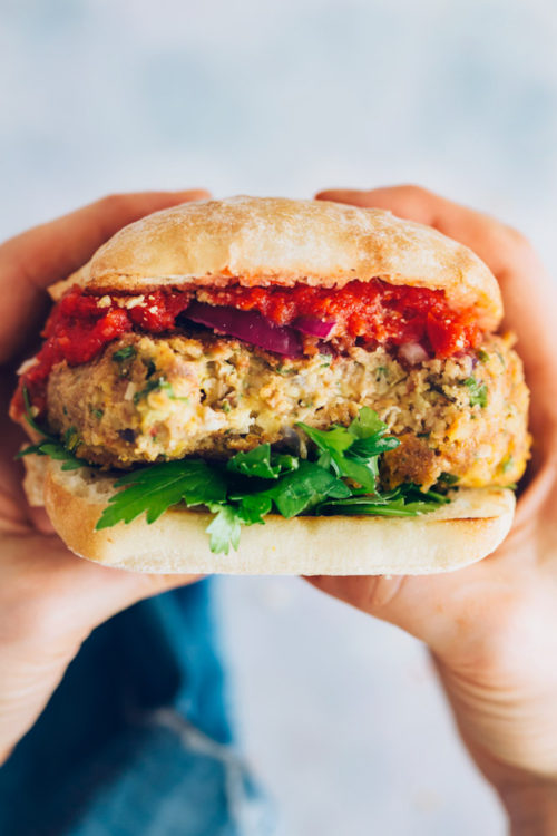 Holding up a Vegan Pizza Burger