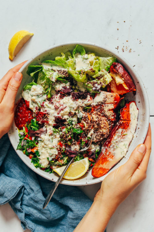 Hands holding the sides of a Sweet Potato Nourish Bowl