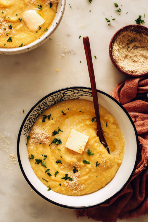 Bowl of polenta topped with fresh parsley and vegan butter