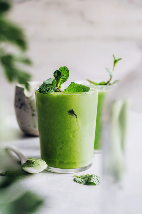 Glass of our iced matcha latte with fresh mint