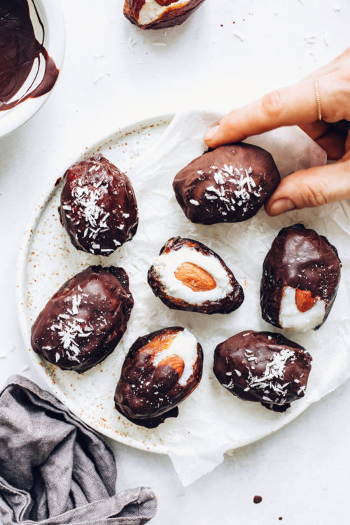 Plate of almond joy stuffed dates topped with desiccated coconut