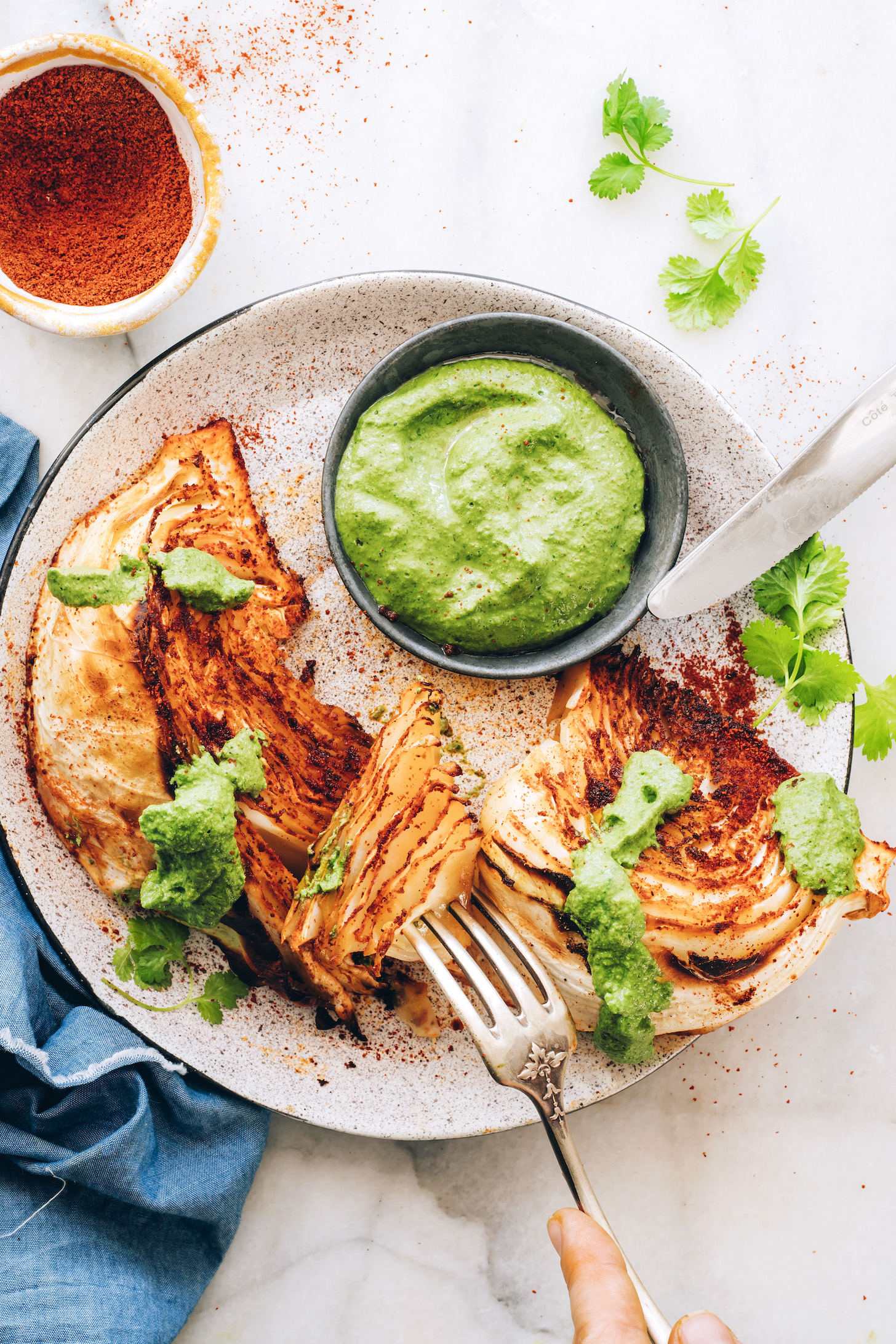 Fork pressing into a bite of a shawarma roasted cabbage wedge