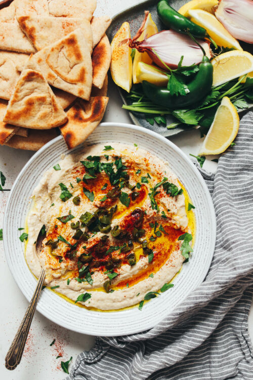 Flatbread next to a bowl or serrano white bean dip