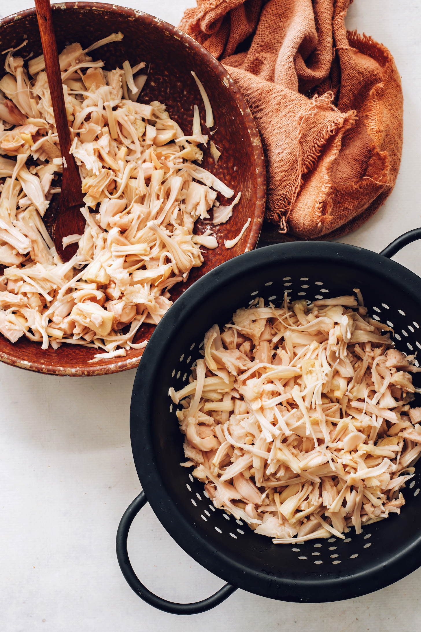 Bowl and colander of shredded  young jackfruit