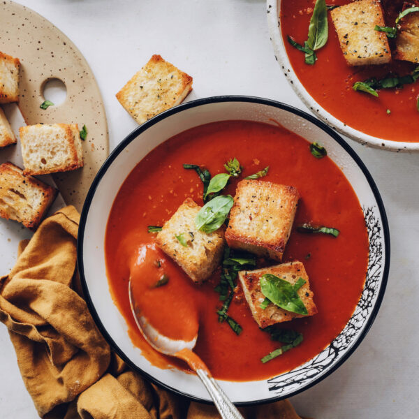Spoon in a bowl of creamy tomato soup