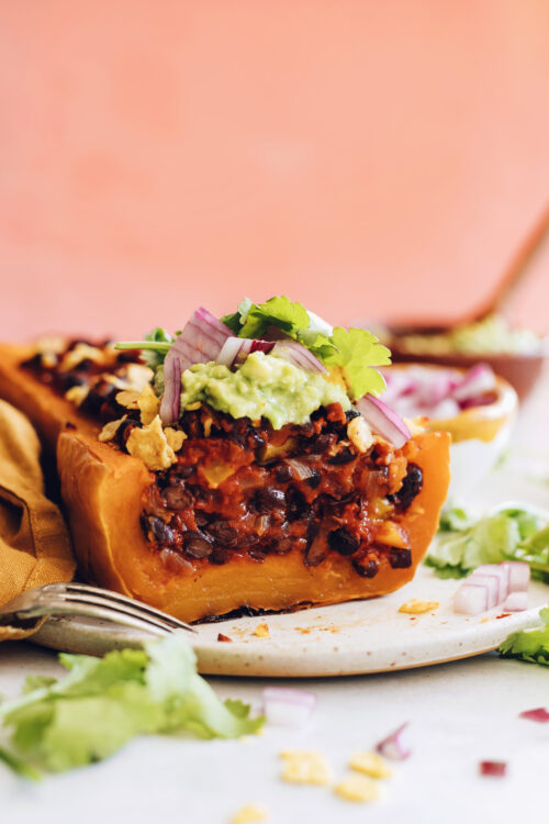Close up shot of a stuffed squash with black bean enchilada filling