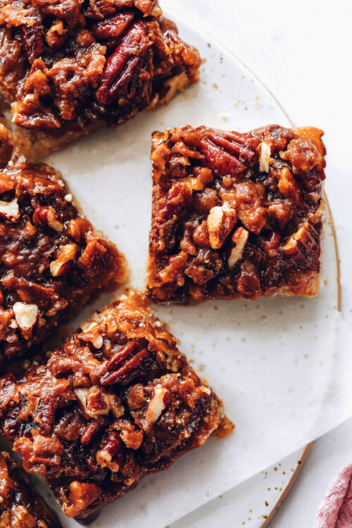 Decadent pecan pie bars on a ceramic tray